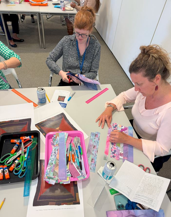 Three people making art with strips of marbled paper during Pew workshop